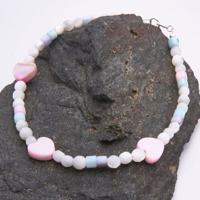 Mother of Pearl Heart Trio Bracelet shown on dark grey stone