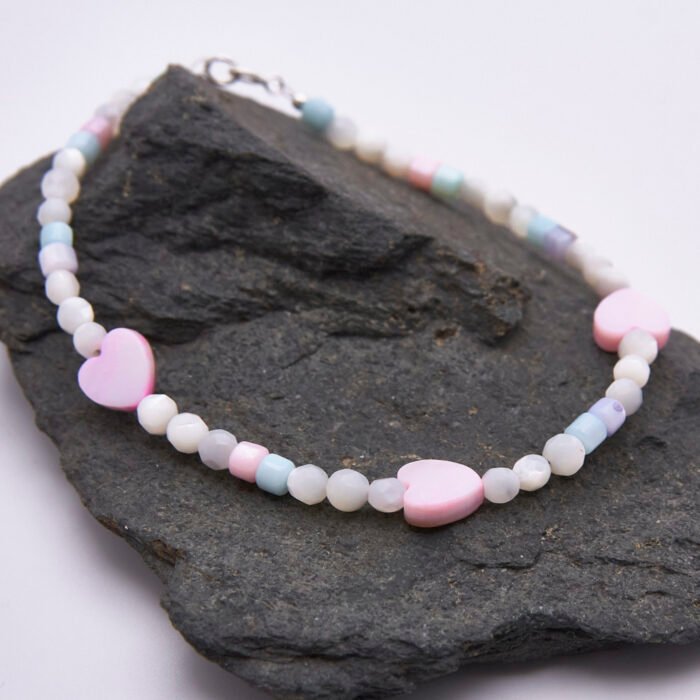 Mother of Pearl Heart Trio Bracelet shown on dark grey stone