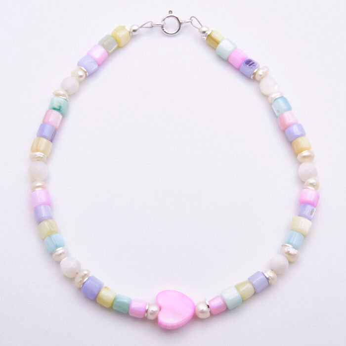 Mother of Pearl and Freshwater Pearl Single Heart Bracelet Mother of Pearl and Freshwater Pearl Heart Bracelet shown from above on flat white surface