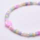 Mother of Pearl and Freshwater Pearl Single Heart Bracelet Mother of Pearl and Freshwater Pearl Single Heart Bracelet close up of beads and heart on flat white surface