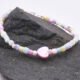 Mother of Pearl and Freshwater Pearl Single Heart Bracelet Mother of Pearl and Freshwater Pearl Single Heart Bracelet close up of heart on dark grey stone