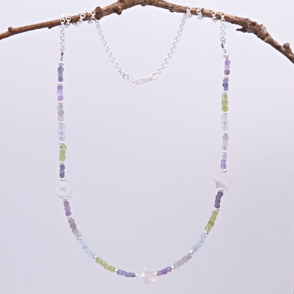 Mixed Gemstone and Mother of Pearl Star Sterling Silver Necklace comprising a selection of faceted gemstone cube beads all measuring around 2.5mm, interspersed with 2mm sterling silver rounds, with three lustrous chunky Mother of Pearl stars equally spaced between the gemstones. The remainder is made up of sterling silver rolo chain finished with a spring ring clasp stamped 925. Necklace is shown hanging from twig.