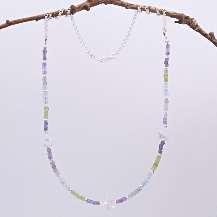 Mixed Gemstone and Mother of Pearl Star Sterling Silver Necklace comprising a selection of faceted gemstone cube beads all measuring around 2.5mm, interspersed with 2mm sterling silver rounds, with three lustrous chunky Mother of Pearl stars equally spaced between the gemstones. The remainder is made up of sterling silver rolo chain finished with a spring ring clasp stamped 925. Necklace is shown hanging from twig.