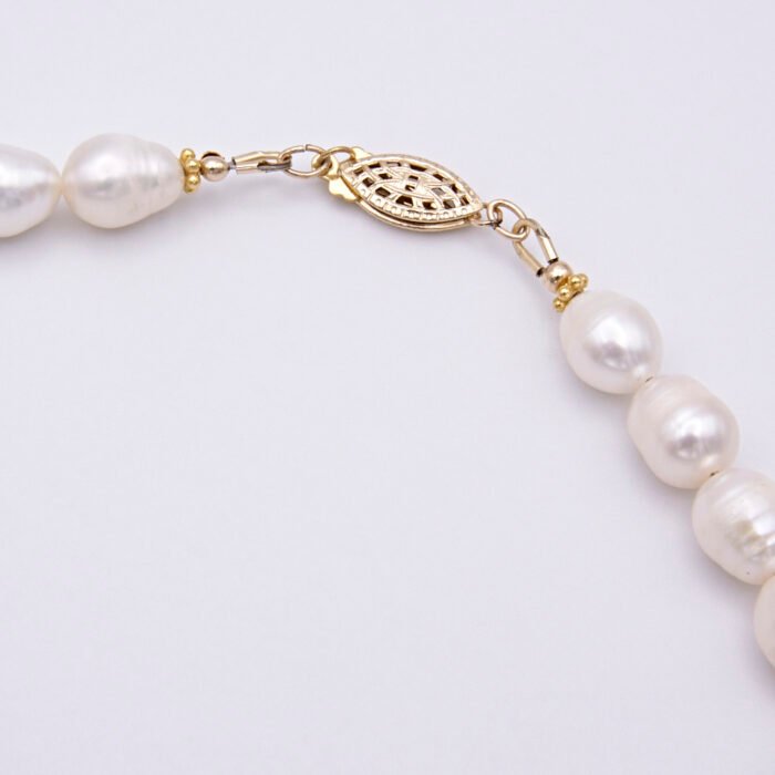 Close up of clasp on Rustic Freshwater Pearl and Gold Necklace Close up of clasp on Rustic Freshwater Pearl and Gold Necklace