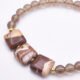 Zebra Jasper and Smoky Quartz Bracelet with Gold Filled Magnetic Clasp close up of Zebra Jasper beads on plain white surface