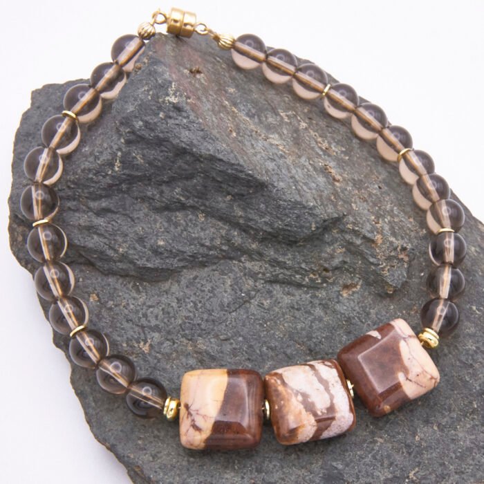 Zebra Jasper and Smoky Quartz Bracelet with Gold Filled Magnetic Clasp shown on dark grey stone
