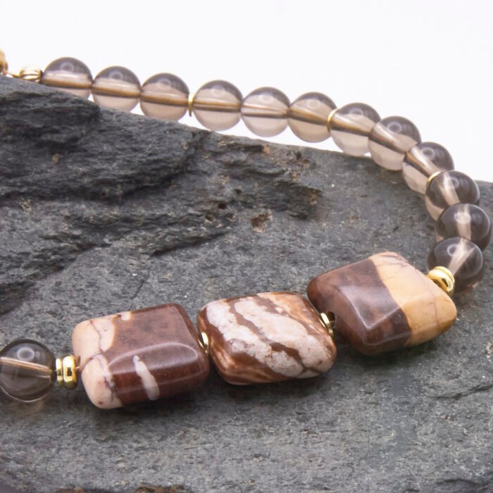 Zebra Jasper and Smoky Quartz Bracelet with Gold Filled Magnetic Clasp close up of Zebra Jasper stones on dark grey stone
