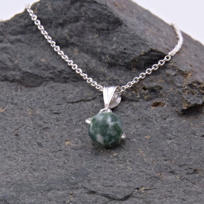 Green Spot Jasper Bead Pendant Necklace close up different angle laid on grey stone