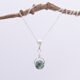 Green Spot Jasper Bead Pendant Necklace hanging from twig
