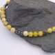 Yellow Turquoise and Hematite Bead Necklace close up of beads on dark grey stone