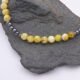 Yellow Turquoise and Hematite Necklace close up of beaded sections on grey rock