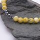 Yellow Turquoise and Hematite Necklace close up of beaded sections on dark grey rock