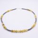 Yellow Turquoise and Hematite Necklace viewed flat from front to back on plain white surface