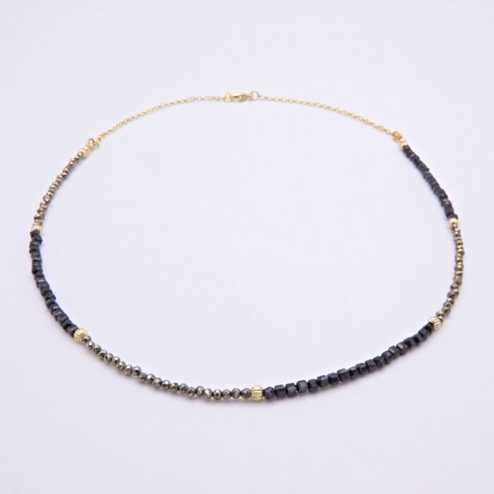 Black Spinel and Pyrite Necklace laid on flat surface