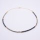 Black Spinel and Pyrite Necklace laid on flat surface
