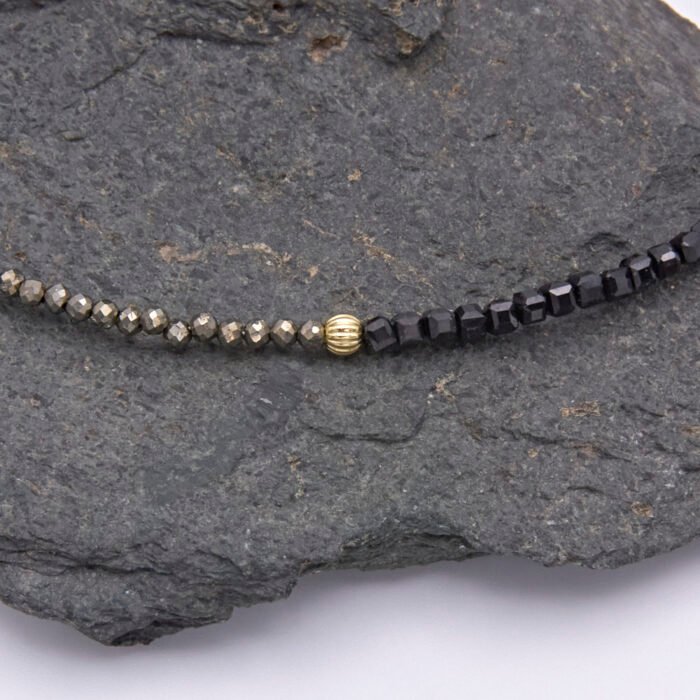 Black Spinel and Pyrite Necklace close up of Pyrite and Black Spinel beads with gold corrugated bead in centre