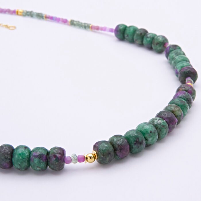Ruby, Green Apatite and Ruby Zoisite Necklace close up of Ruby Zoisite sections of necklace on flat surface