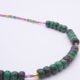 Ruby, Green Apatite and Ruby Zoisite Necklace close up showing most of Ruby Zoisite sections and some Ruby and Green Apatite on flat surface
