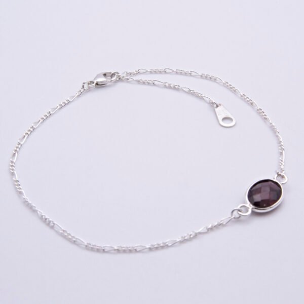 Sterling Silver Bezel-set Garnet Bracelet shown on flat white surface