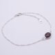 Sterling Silver Bezel-set Garnet Bracelet shown on flat white surface