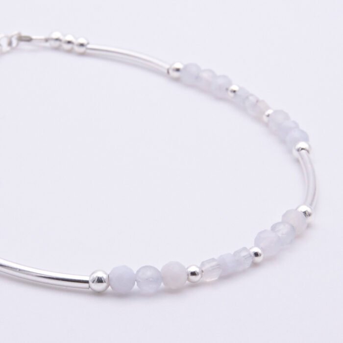 Blue Lace Agate and Sterling Silver Bracelet close up of beads on flat white surface