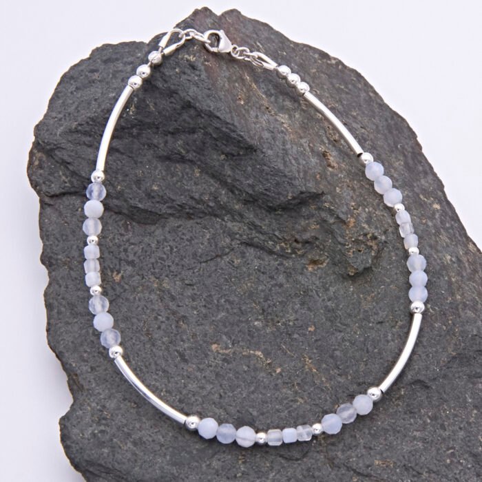 Blue Lace Agate and Sterling Silver Bracelet shown on dark grey stone