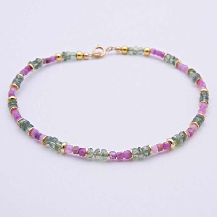 Ruby and Green Apatite Bracelet focus from front to back on flat white surface