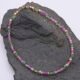 Ruby and Green Apatite Bracelet shown laid flat on dark grey stone