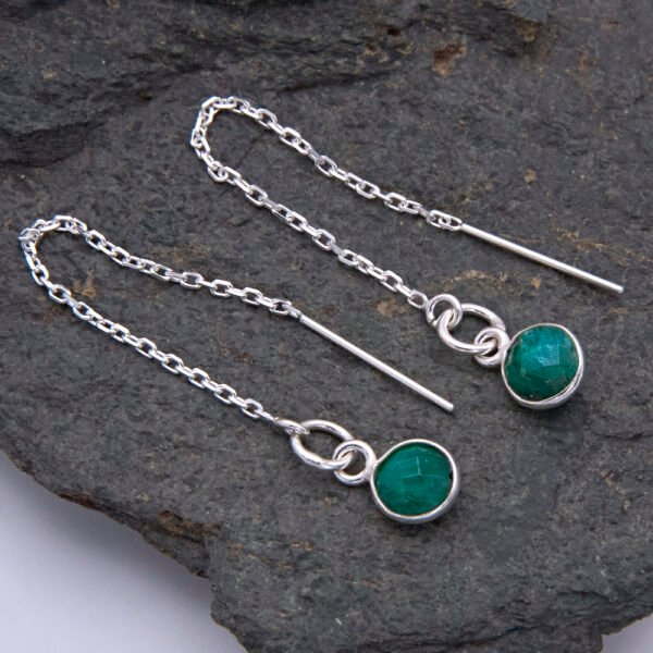 Emerald Sterling Silver Threader Earrings shown laid flat on a dark grey stone