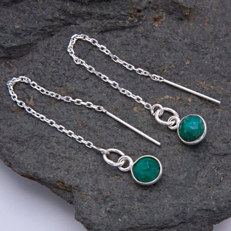 Emerald Sterling Silver Threader Earrings shown laid flat on a dark grey stone