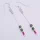 Ruby and Ruby Zoisite Sterling Silver Dangle Earrings laid flat on a white surface
