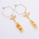 Bee and Natural Amber Chip Dangles on Hexagon Shaped Ear Wires laid flat on white surface