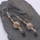 Picasso Jasper, Smoky Quartz and Smoky Watermelon Quartz mixed metals dangle earrings Picasso Jasper, Smoky Quartz and Smoky Watermelon Quartz mixed metals dangle earrings shown laid flat on dark grey stone
