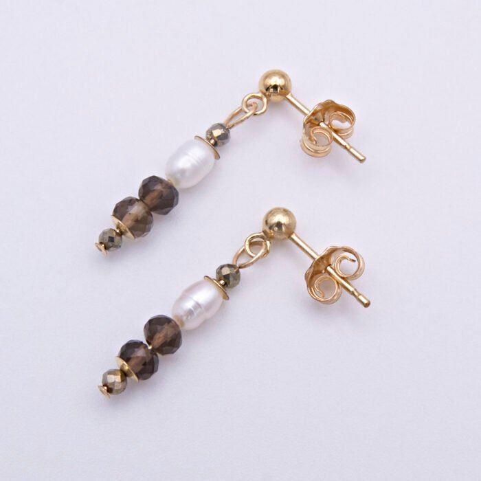 Freshwater Pearl, Smoky Quartz and Pyrite Gold Filled Earrings Freshwater Pearl, Smoky Quartz and Pyrite Gold Filled Earrings lying next to each other at an angle with one above the other