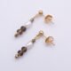 Freshwater Pearl, Smoky Quartz and Pyrite Gold Filled Earrings Freshwater Pearl, Smoky Quartz and Pyrite Gold Filled Earrings lying next to each other at an angle with one above the other