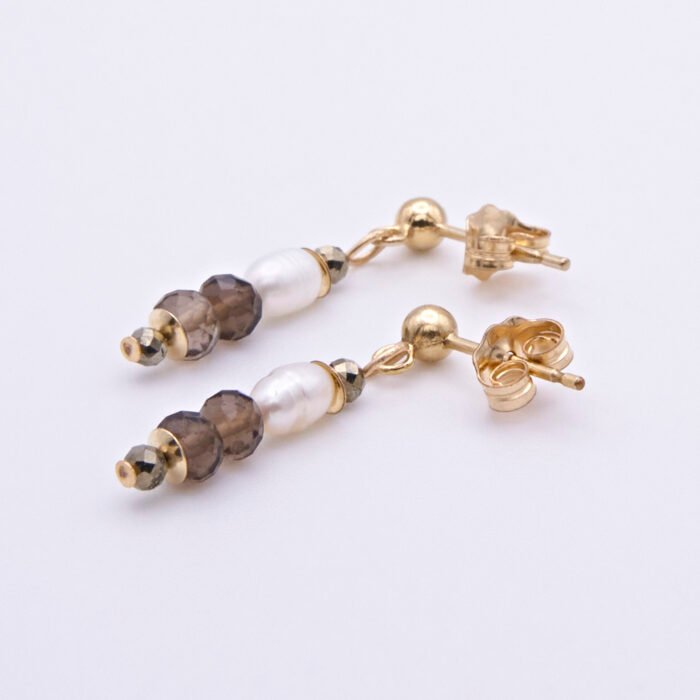 Freshwater Pearl, Smoky Quartz and Pyrite Gold Filled Earrings Freshwater Pearl, Smoky Quartz and Pyrite Gold Filled Earrings lying one above the other on a flat white surface