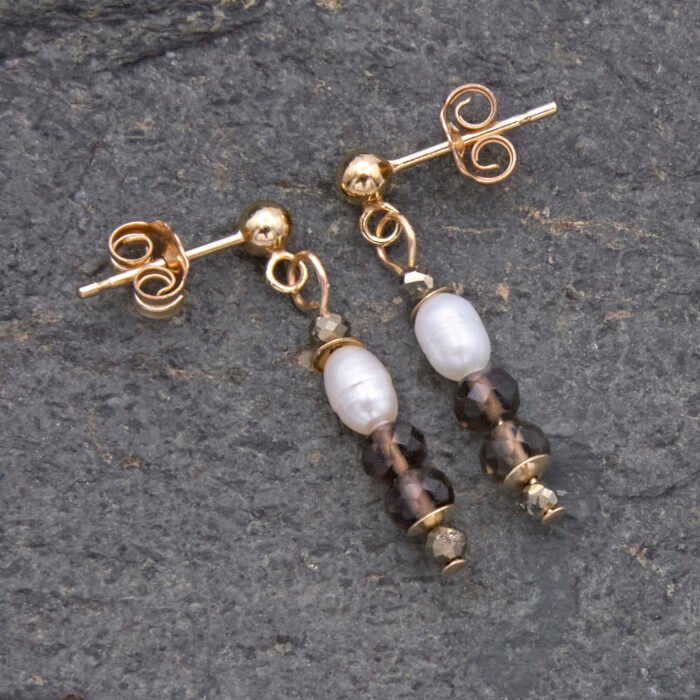 Freshwater Pearl, Smoky Quartz and Pyrite Gold Filled Earrings Freshwater Pearl, Smoky Quartz and Pyrite Gold Filled Earrings shown lying flat on grey stone