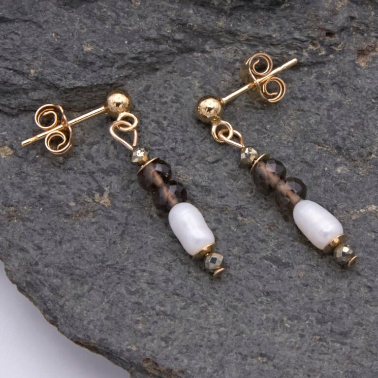 Smoky Quartz, Pyrite and Freshwater Rice Pearl Dangles on Gold Filled Ear Studs Smoky Quartz, Pyrite and Freshwater Rice Pearl Dangles on Gold Filled Ear Posts with Ball Stud at end, shown laid flat on dark grey stone