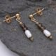 Smoky Quartz, Pyrite and Freshwater Rice Pearl Dangles on Gold Filled Ear Studs Smoky Quartz, Pyrite and Freshwater Rice Pearl Dangles on Gold Filled Ear Posts with Ball Stud at end, shown laid flat on dark grey stone