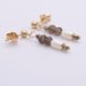 Smoky Quartz, Pyrite and Freshwater Rice Pearl Dangles on Gold Filled Ear Studs Smoky Quartz, Pyrite and Freshwater Rice Pearl Dangles on Gold Filled Ear Studs shown side on on a flat white surface