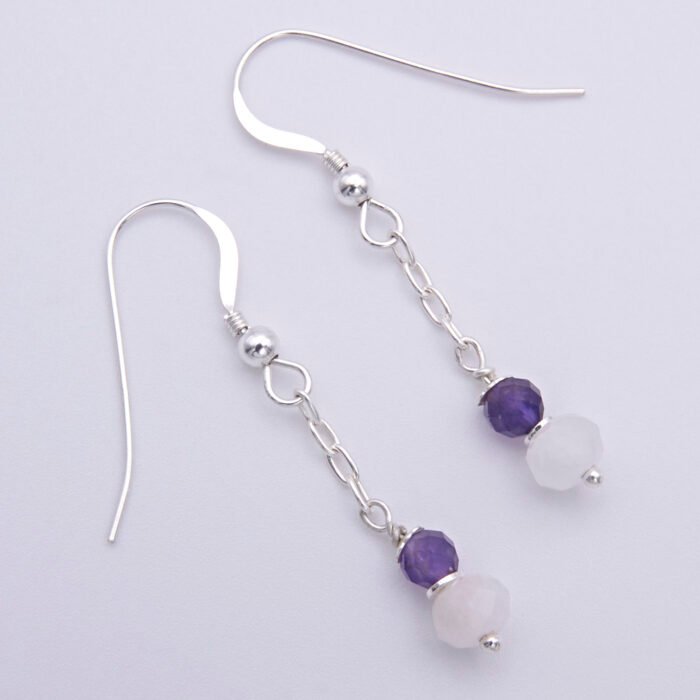 Amethyst and Rainbow Moonstone Sterling Silver Dangle Earrings shown top down laid flat on white surface
