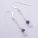 Amethyst and Rainbow Moonstone Sterling Silver Dangle Earrings shown top down laid flat on white surface