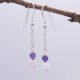 Amethyst and Rainbow Moonstone Dangle Earrings shown hanging from twig