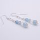 Aquamarine and Rainbow Moonstone Sterling Silver Earrings laid flat, side view