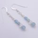 Aquamarine and Rainbow Moonstone Sterling Silver Earrings laid flat on white background