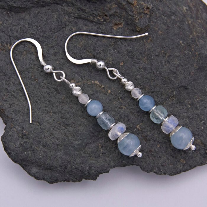 Aquamarine and Rainbow Moonstone Sterling Silver Earrings shown on dark grey stone