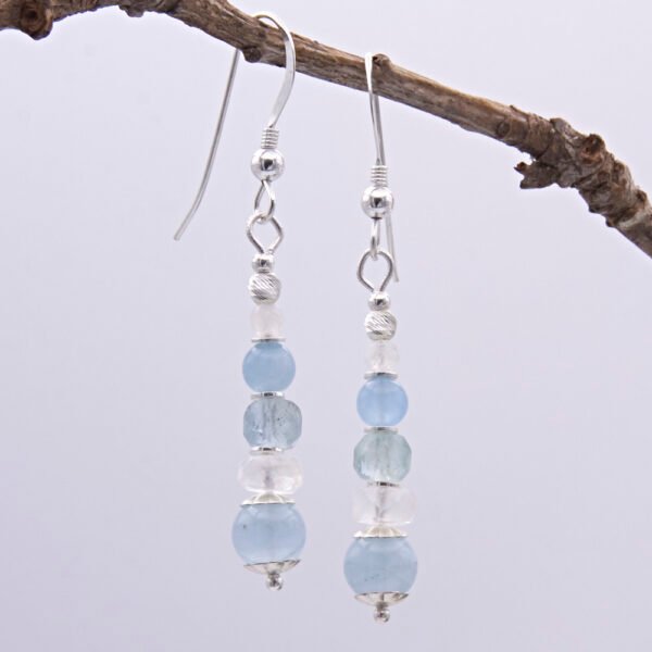 Aquamarine and Rainbow Moonstone Sterling Silver Stack Earrings shown hanging from twig