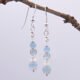 Aquamarine and Rainbow Moonstone Sterling Silver Stack Earrings shown hanging from twig