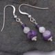 Purple Banded Agate, Rainbow Moonstone and Amethyst Sterling Silver Drop Earrings Purple Banded Agate, Rainbow Moonstone and Amethyst Sterling Silver Drop Earrings shown from above on dark grey stone