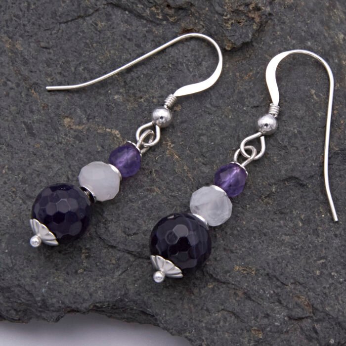 Amethyst, Rainbow Moonstone and Purple Banded Agate Stack Drop Sterling Silver Earrings shown from above on dark grey stone
